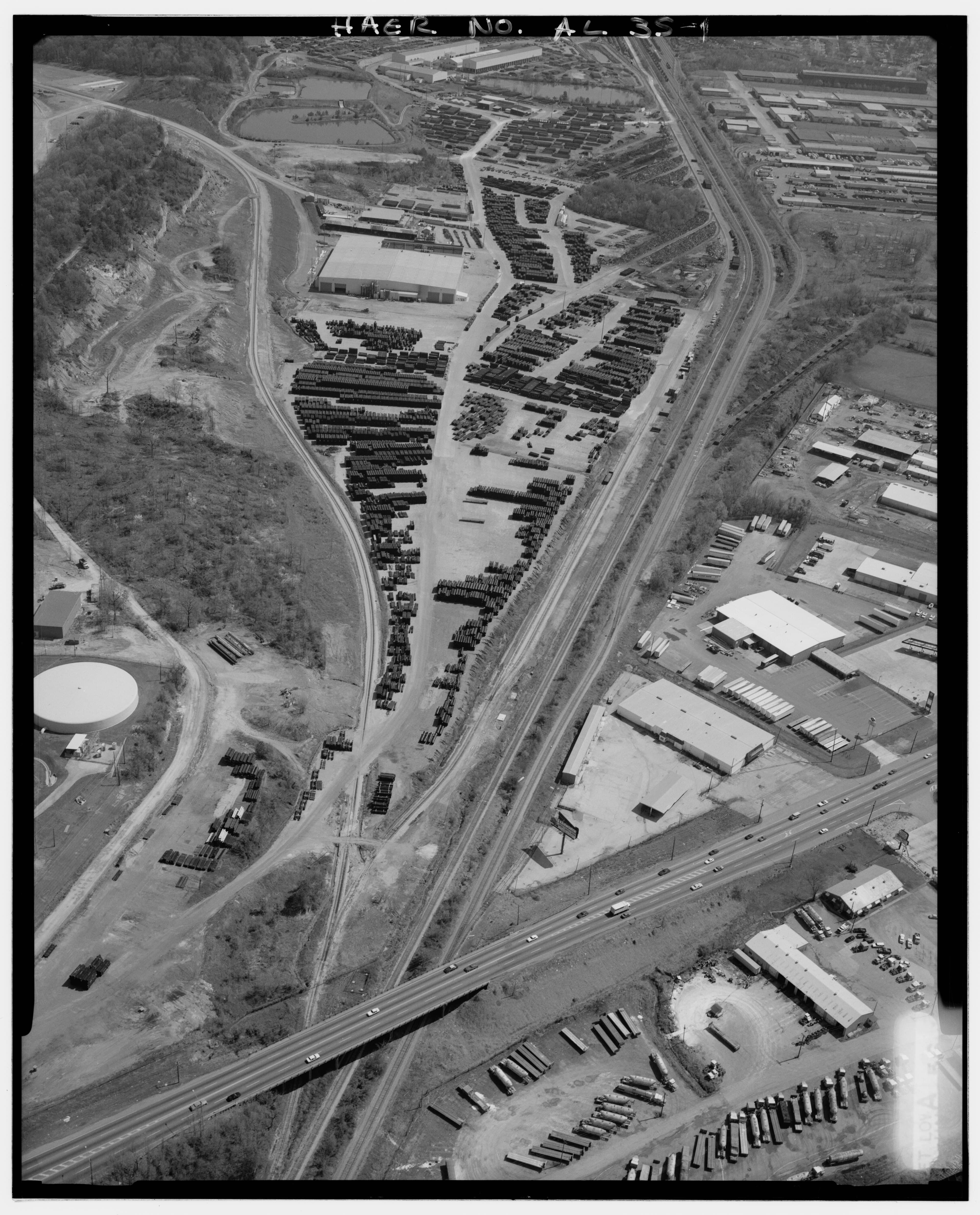 Aerial photograph of a large pipe laydown yard with rows of staged materials and access lanes